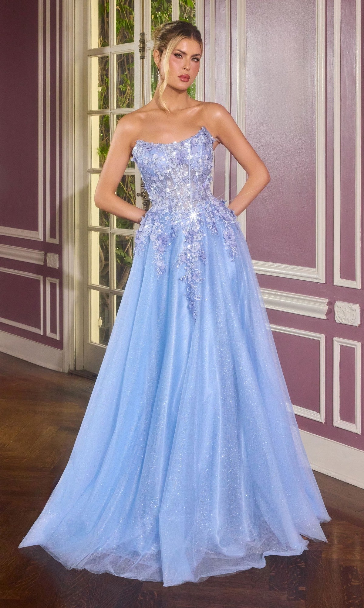 A woman stands indoors wearing the Ladivine C174, a blue long prom dress with 3D floral embroidery and a sparkling tulle skirt.